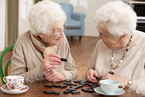 Two,Senior,Women,Playing,Dominoes,At,Day,Care,Centre