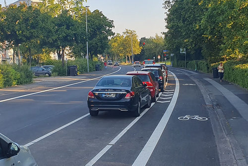 Parkende Autos neben dem Radweg